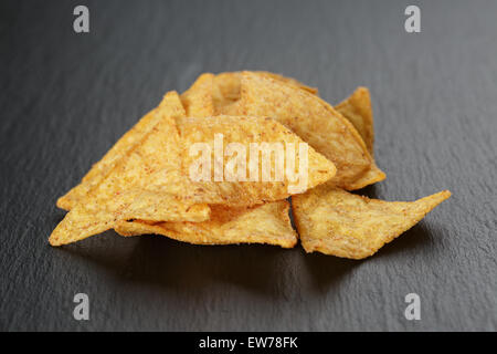 tortilla nachos on dark slate board Stock Photo