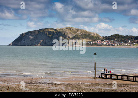 UK, Wales, Conwy, Llandudno North Beach, view towards Little Orme, across boat jetty at low tide Stock Photo