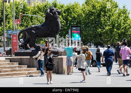 Asian tourists taking pictures of themselves with the phone in Les Ramblas of Barcelona, Catalonia, Spain Stock Photo