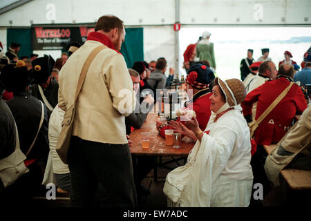 Lions Mound, Belgium . 18th June, 2015. Waterloo, Re-enactors from different countries gathered in Waterloo to participate in the commemoration for the 200th anniversary of the Battle of Waterloo. 18th June, 1815. People dressed in costume of the 19th century drink beer at a camp in Waterloo, Belgium, June 18, 2015. Re-enactors from different countries gathered in Waterloo to participate in the commemoration for the 200th anniversary of the Battle of Waterloo, bringing to life the legendary battle happening on June 18, 1815. Credit:  Zhou lei/Xinhua/Alamy Live News Stock Photo