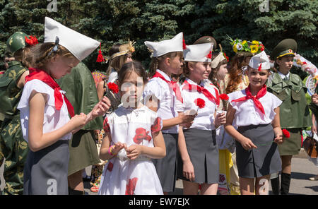 Line of young girls in traditional Red Army Uniforms and Communist Pioneer uniforms as part of the Russia Day celebrations in Uf Stock Photo