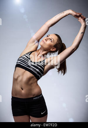Beginning female yogi practicing yoga inversion poses standing on hands  upside down leaning against wall in fitness club Stock Photo | Adobe Stock