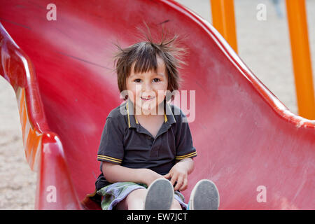 Adorable little boy, playing on the playground, having fun Stock Photo