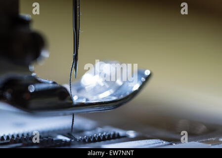 A macro shot of the needle and thread on an electric sewing machine. Stock Photo