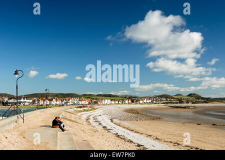 UK, Wales, Conwy, Llandudno, West Shore, two women sat in sunshine above empty beach Stock Photo
