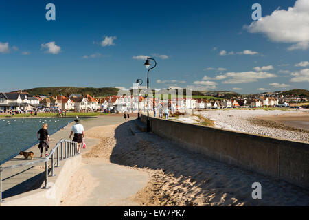 UK, Wales, Conwy, Llandudno, West Shore, people walking dog past paddling pool Stock Photo