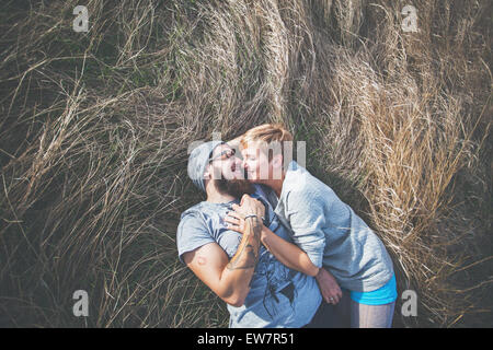 Elevated view of a couple lying on the grass Stock Photo