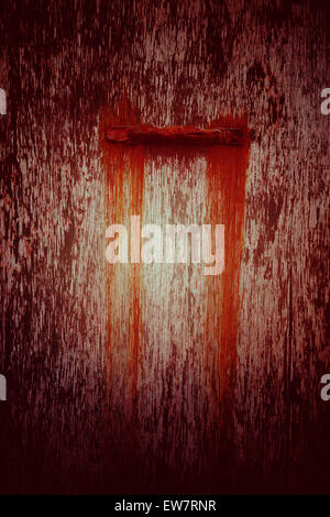 Red peeling paint with stain from handle Stock Photo