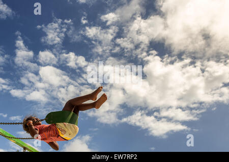 Girl on a swing mid air Stock Photo