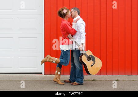 Couple standing in the street kissing Stock Photo