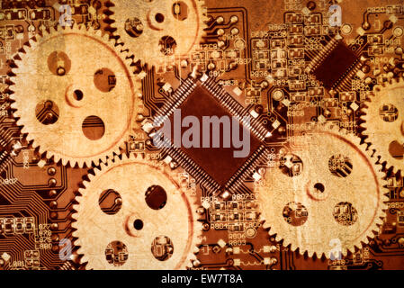 Gears and a circuit board with processor (CPU) of a computer symbolizing mechanic and digital technology. Stock Photo