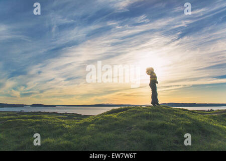 Low angle view of a boy jumping on a hill Stock Photo