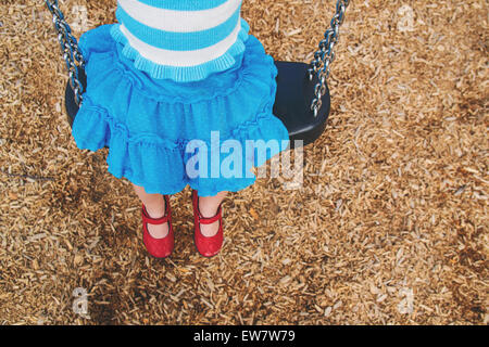 Overhead view of a girl sitting on a swing Stock Photo