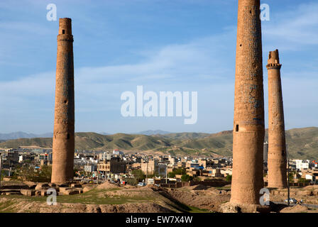 Three tall minarets, once part of a madrassa that was built in the 15th century by the last of the Timurid rulers, tower over a Stock Photo