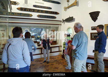 Tour guide gives tour to visitors at the Nantucket Whaling Museum, Nantucket, Massachusetts Stock Photo