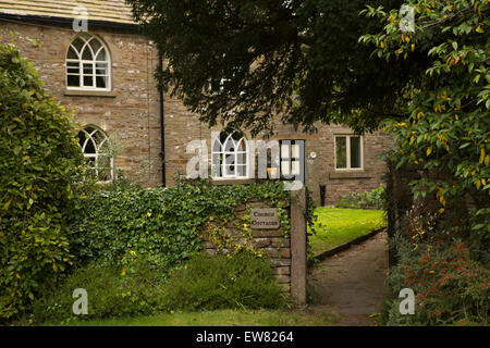 UK, England, Cheshire, Pott Shrigley, church cottages with gothic arched windows next to churchyard Stock Photo