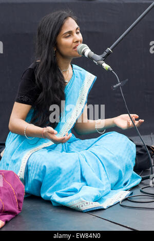 Girl singing in Indian for the Rathayatra parade, Hare Krishna followers in London. Stock Photo