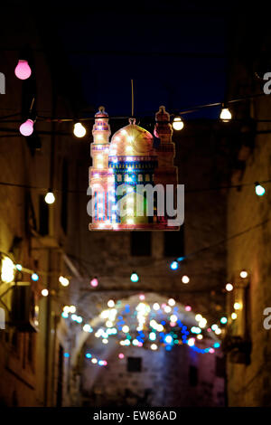 Israel, Jerusalem. 19th June, 2015. An alley in the Muslim Quarter with festive lights during the first Friday of Muslim holy month of Ramadan in the Old City of Jerusalem on 19 June 2015. Ramadan is described as a holy month of sacrifice and worship for the Muslim people, and it’s the most sacred month in the Islamic calendar. Credit:  Eddie Gerald/Alamy Live News Stock Photo