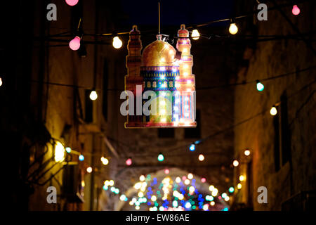 Israel, Jerusalem. 19th June, 2015. An alley in the Muslim Quarter with festive lights during the first Friday of Muslim holy month of Ramadan in the Old City of Jerusalem on 19 June 2015. Ramadan is described as a holy month of sacrifice and worship for the Muslim people, and it’s the most sacred month in the Islamic calendar. Credit:  Eddie Gerald/Alamy Live News Stock Photo