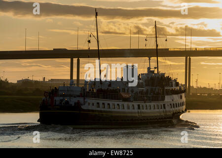 Cumberland Basin, Bristol, UK. 19th June 2015. The MV Balmoral has been out of action for 3 years, undergoing restoration works in Bristol's Floating Harbour. This evening she makes her first journey with passengers, leaving Bristol's Docks and journeying up the River Avon. Here she is saling into the sunset and about to pass under the M5 Motorway Bridge at Avonmouth. Credit:  Carolyn Eaton/Alamy Live News Stock Photo