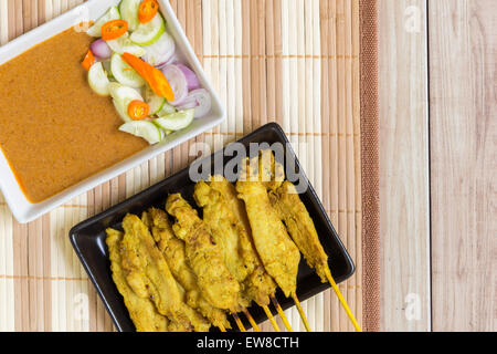 Thai grilled curry pork with peanut sauce and salad. Stock Photo