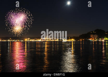 Fireworks on the lakefront of Arona in a summer party night - Piedmont Stock Photo
