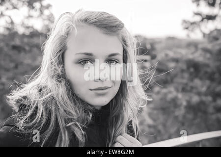 Outdoor closeup monochrome portrait of teenage Caucasian blond girl Stock Photo