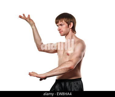 The man trains kata kung fu. Isolated on white background. Healthy lifestyle concept. Stock Photo