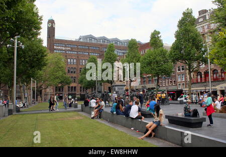 Rembrandtplein square, inner city of Amsterdam The Netherlands. People sitting on the grass in summer. Stock Photo