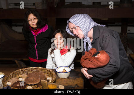 Ireland, Co Wexford, New Ross, steerage passage costumed character with Japanese visitors inside1845 emigrant ship Dunbrody Stock Photo