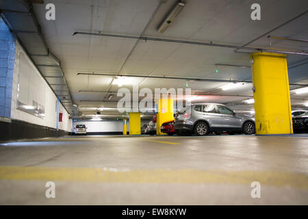 Half empty underground garage or parking lot, with a few cars Stock Photo