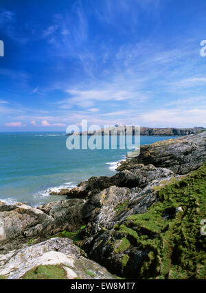 Lighthouse & pilot station on Point Lynas promontory projecting into Irish Sea from E end of Porth Eilian bay seen from Isle of Anglesey Coastal Path. Stock Photo