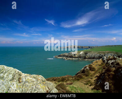 Isle of Anglesey Coastal Path: lighthouse & pilot station on Point Lynas promontory projecting into Irish Sea from Port Eilian. Stock Photo