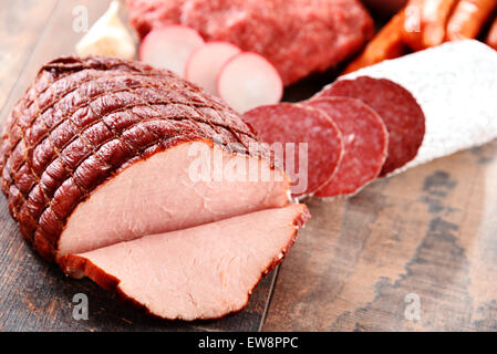 Assorted meat products including ham and sausages. Stock Photo