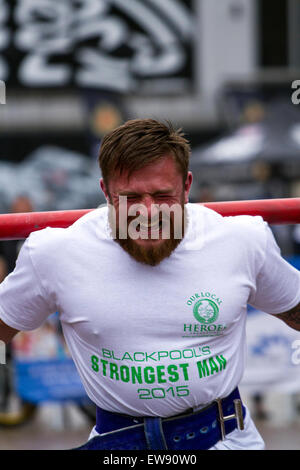 St Johns Square, Blackpool, Lancashire. 20th June, 2015. Joe Nicholson goes head to head in an exciting series of strong man events to determine who will be crowned as Blackpool’s Strongest Man 2015.  'Man Mountain' Joe competes in events such as the 'Yoke Carry', 'Conans Wheel' and the 'Truck Pull' amongst others.  Poor weather conditions didn't deter crowds from flocking to watch this exhibition of strength as part of Blackpool's Armed Forces week. Credit:  Cernan Elias/Alamy Live News Stock Photo