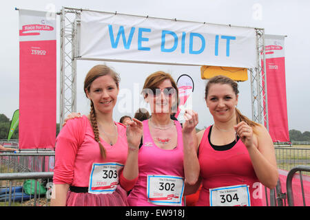 Mother and two daughters show their medals at the finishing line at 'Race for LIfe' women-only charity fundraising running event for Cancer Research UK. 20th June, 2015. Kempton Park racecourse, Staines Road East, Sunbury on Thames, Middlesex, England, Great Britain, United Kingdom, UK, Europe. Credit:  Ian Bottle / Alamy Live News Stock Photo