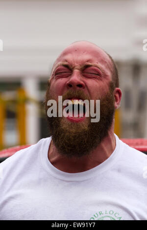 St Johns Square, Blackpool, Lancashire. 20th June, 2015. Strongmen go head to head in an exciting series of strong man events to determine who will be crowned as Blackpool’s Strongest Man 2015.  Events such as the 'Yoke Carry', 'Conan’s Wheel' and the 'Truck Pull' amongst others, test these immensely strong men to their physical limits.  Poor weather conditions didn't deter crowds from flocking to watch this exhibition of strength as part of Blackpool's Armed Forces week. Credit:  Cernan Elias/Alamy Live News Stock Photo