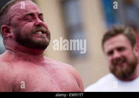 St Johns Square, Blackpool, Lancashire. June, 2015.  Richard Hanson, facial grimace, weightlifter competitor at the Charity Strongman event which is hosted by Blackpool BID. Blackpool's Strongest Man Competition kicked off National Armed Forces Week in style with Ex Forces Personnel and Civilians alike proving themselves in strong man events to win the male weight lifter coveted, virility, manliness, maleness, exertion vigour, strength, muscularity, ruggedness, toughness, robustness masculinity title. Stock Photo