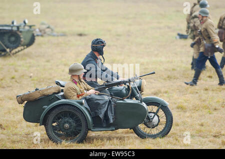 RUSSIA, BORODINO - OCTOBER 12: Unidentified armed soldiers drive on motorbike on reenactment of the battle in WWII near the Borodino village in 1941, in Moscow region, Borodino, on 12 October, 2014, Russia Stock Photo