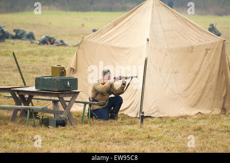 RUSSIA, BORODINO - OCTOBER 12: Unidentified armed soldier near the tent shooting on reenactment of the battle in WWII near the Borodino village in 1941, in Moscow region, Borodino, on 12 October, 2014, Russia Stock Photo