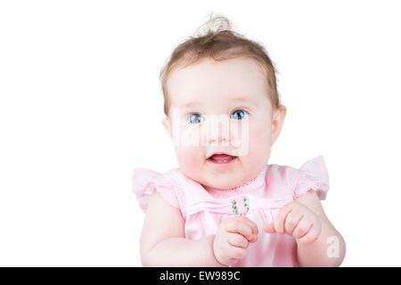 Close up portrait of a beautiful baby girl in a pink dress, isolated on white Stock Photo