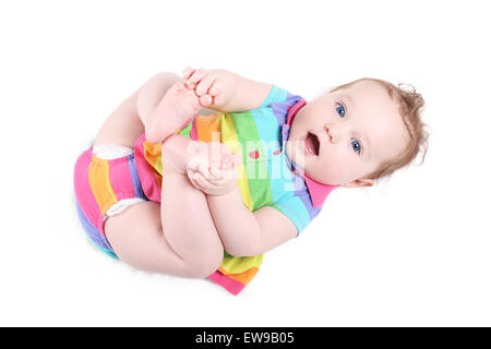 Funny baby girl playing with her feet, isolated on white Stock Photo
