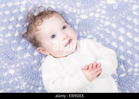 Adorable little baby on a blue knitted blanket Stock Photo