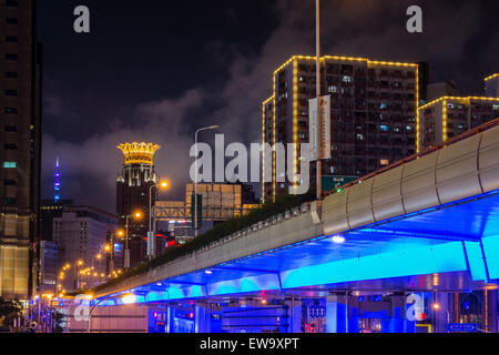 Illuminated underbelly of city bridge Stock Photo