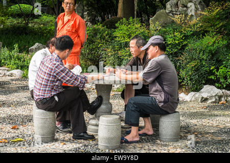 Men playing cards outside Stock Photo