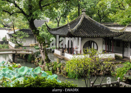 Traditional Chinese house and pavilion surrounded by a water garden in the classical Chinese Suzhou Gardens, China Stock Photo