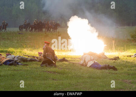 RUSSIA, CHERNOGOLOVKA - MAY 17: Kornilovs hiking squad lying on grass and shoot  on History reenactment of battle of Civil War in 1914-1919 on May 17, 2014, Russia Stock Photo