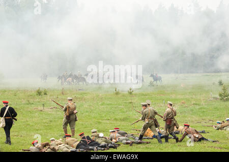 RUSSIA, CHERNOGOLOVKA - MAY 17: Kornilovs hiking squad lying on grass and shoot  on History reenactment of battle of Civil War in 1914-1919 on May 17, 2014, Russia Stock Photo