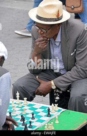 A man in deep concentration during a chess match in Union Square Park in New York City. Stock Photo