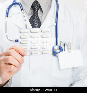 Doctor holding pills in hand - close up shot Stock Photo